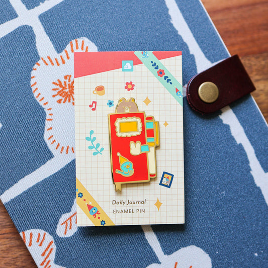 Pin’s émaillé – Journal quotidien